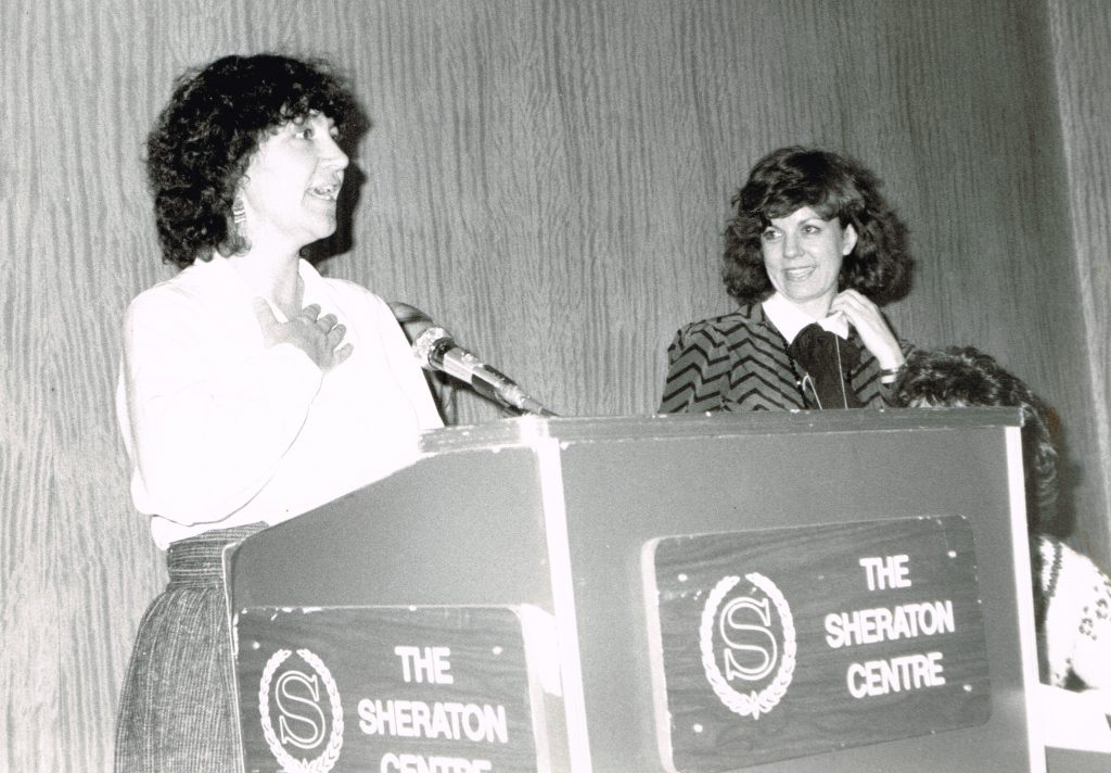 This photo shows feminists and union activists Deirdre Gallagher and Wendy Cuthbertson at an OFL Women's Committee presentation at the 1982 OFL Convention.