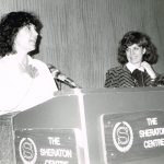 This photo shows feminists and union activists Deirdre Gallagher and Wendy Cuthbertson at an OFL Women's Committee presentation at the 1982 OFL Convention.