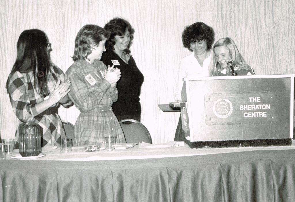 This black and white photo was taken at a Women's Committee presentation during the 1982 OFL Convention and shows (r to l) Janis Sarra, Deirdre Gallagher, Frances Lankin, Jean Robertson and unknown sister.