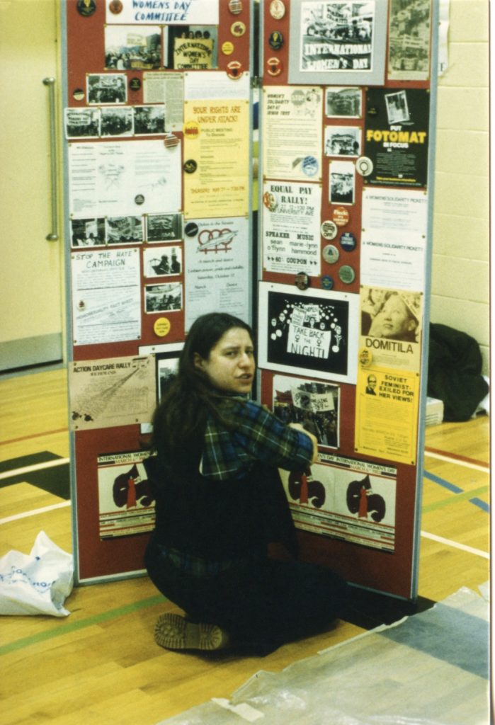 This photo shows Amy Gottlieb setting up a display about the activism of the International Women's Day Committee at the 1982 Toronto IWD Fair.