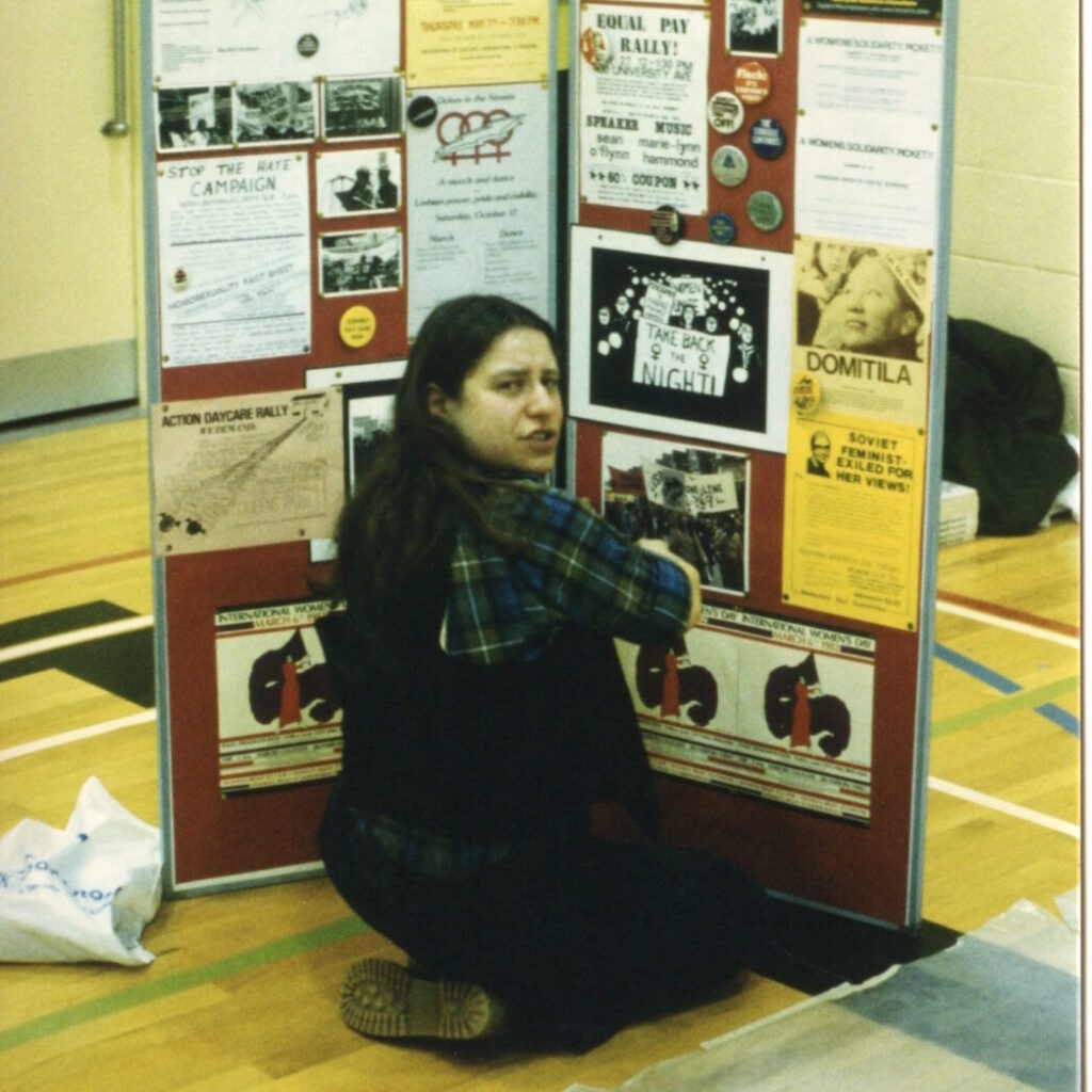 This photo shows Amy Gottlieb setting up a display about the activism of the International Women's Day Committee at the 1982 Toronto IWD Fair.