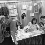 The photo is of the Montreal Health Press at a conference booth table, Toronto, 1992. Photo taken by Judith Lermer Crawley.