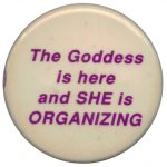 A button proclaiming the presence and power of feminist organizing for change.