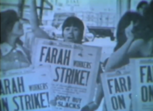 Still from the film "Rising Up Strong" featuring a blurry archival image of white women holding placards that say "Farah Workers Strike!".