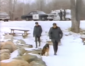 Still from the film "Conspiracy of Silence" featuring a blurry image of two white men walking in the snow with a dog.