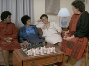 Still from the film "Older, Stronger, Wiser" featuring four older black women sitting in a living room and talking.