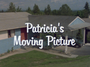 Still from the film "Patricia's Moving Picture" featuring a shot of a suburban house and the words "Patricia's Moving Picture" in white font.