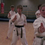 Still from the film "Spirit of the Kata" depicting four white women doing karate in a gym.