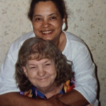 Still from the film "Motherland: Tales of Wonder" featuring Florence Clark, a biracial woman who is one of the subjects of the film, hugging her mother.