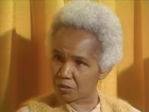 Still from a 1980 interview featuring Rosemary Brown, an older black woman with cropped white hair.