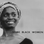 Still from the film "Some Black Women" featuring a black and white archival photograph of a black woman wearing a head wrap smiling and looking into the distance. On top of the image are the words "SOME BLACK WOMEN."