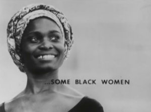 Still from the film "Some Black Women" featuring a black and white archival photograph of a black woman wearing a head wrap smiling and looking into the distance. On top of the image are the words "SOME BLACK WOMEN."