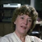 Still from the film "Love Affair with Politics" depicting Marion Dewar, a middle aged white woman with curly light brown hair, speaking to the camera.