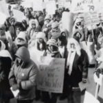 Still featuring a blurry black and white archival image of nurses striking.