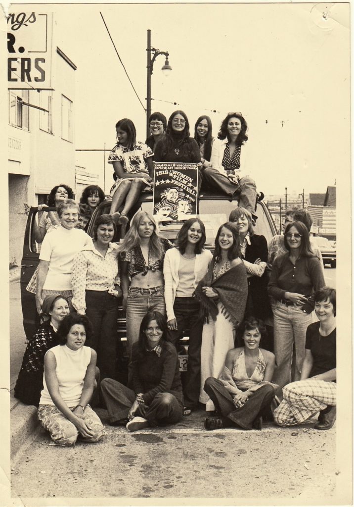 Twenty women pose in front of the Isis touring van in Vancouver 1974. The women include Isis members and representatives from each town on the tour. Each town tailor made its own 2-3 day festival. Kathleen Shannon, the director of the Working Mothers Series and the founder and first executive producer of Studio D of the National Film Board, flew in from Montreal to give us workshops on how to hold a meaningful film discussion.