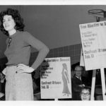 Paula Fletcher (left) standing in a crowd with signs demanding free abortion during a protest in Sault Ste. Marie in 1971.