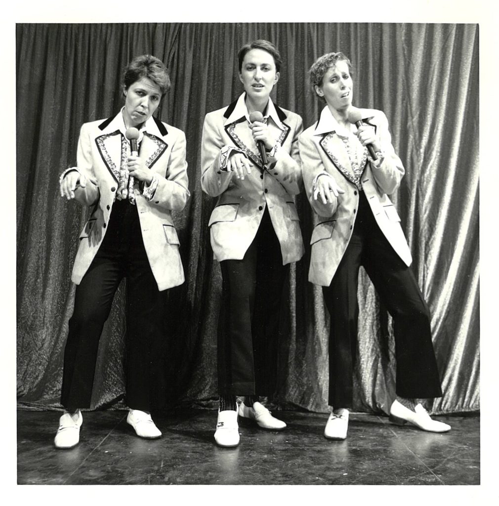 The Clichettes sing "Having My Baby" in 1986 photo. Left to right: Johanna Householder, Louise Garfield, Janice Hladski. Photographer: David Hlynsky