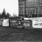 Photo of one section of the Banner Project showing CUPE 2424 slogans including "Tory Economics = Working Poor" as well as the Women's Centre, St. Thomas University's "Fight Sexism; Fight Racism". Women's groups across Canada were asked to produce a protest banner that would become part of a huge banner in Ottawa. The goal was to show the strength and solidarity of women during the Third Commonwealth meeting of Ministers Responsible for Women’s Affairs in October 1990.