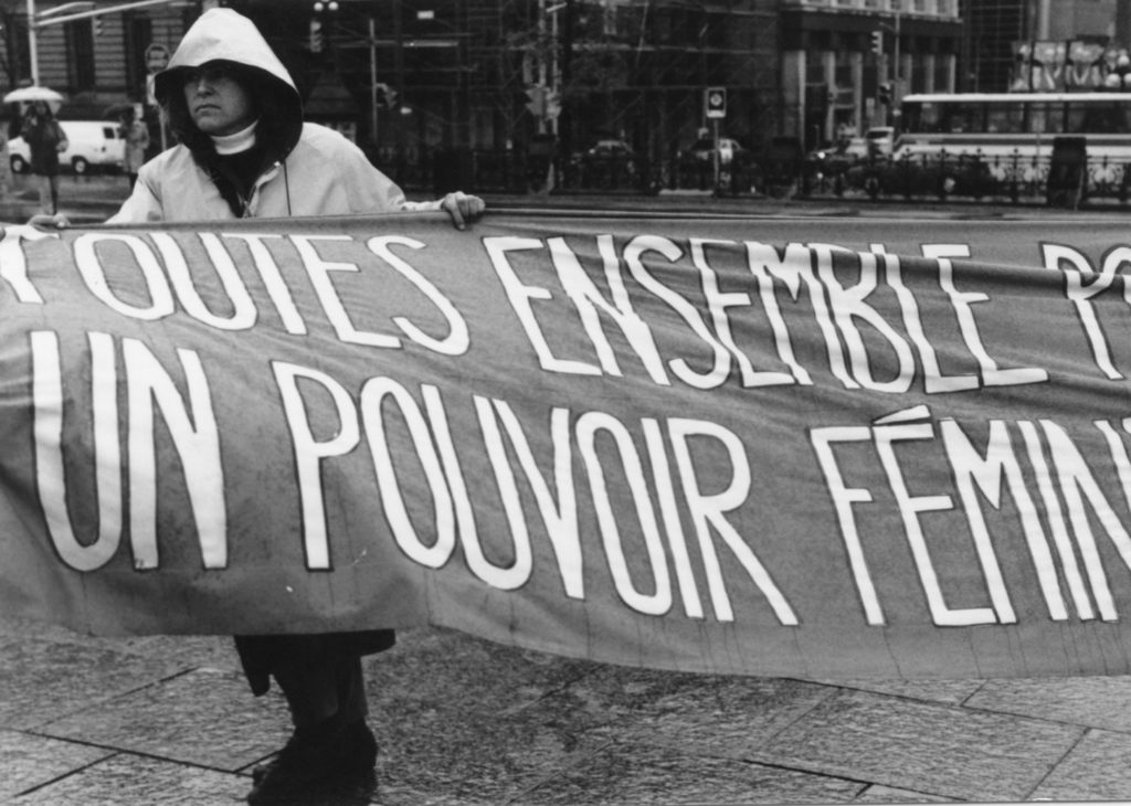 Photo of one section of the Banner Project and featuring the message, "Toutes ensemble pour un pouvoir féministe". Women's groups across Canada were asked to produce a protest banner that would become part of a huge banner in Ottawa. The goal was to show the strength and solidarity of women during the Third Commonwealth meeting of Ministers Responsible for Women’s Affairs in October 1990.