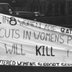 Photo of a banner highlighting violence against women and the impact of funding cuts to women's programs and services. It was part of the Banner Project, which asked women's groups across Canada to produce a protest banner that would become part of a huge banner in Ottawa. The goal was to show the strength and solidarity of women during the Third Commonwealth meeting of Ministers Responsible for Women’s Affairs in October 1990.