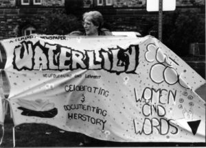 Photo of the protest banner created for the Banner Project by Waterlily, a feminist newspaper in Newfoundland and Labrador. Women's groups across Canada were asked to produce a protest banner that would become part of a huge banner in Ottawa. The goal was to show the strength and solidarity of women during the Third Commonwealth meeting of Ministers Responsible for Women’s Affairs in October 1990.