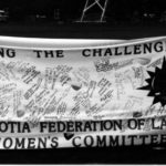 The Nova Scotia Federation of Labour Women's Committee banner was filled with dozens of signatures alongside the slogan "Facing the Challenges". It was part of The Banner Project which asked women's groups across Canada to produce a protest banner that would become part of a huge banner in Ottawa. The goal was to show the strength and solidarity of women during the Third Commonwealth meeting of Ministers Responsible for Women’s Affairs in October 1990.