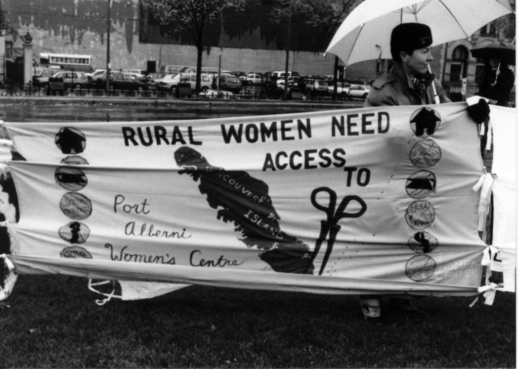 The slogan of the Port Alberni Women's Centre banner was "Rural women need access to...." along with a list that included jobs, education, social services, and housing. It was part of the Banner Project which asked women's groups across Canada to produce a protest banner that would become part of a huge banner in Ottawa. The goal was to show the strength and solidarity of women during the Third Commonwealth meeting of Ministers Responsible for Women’s Affairs in October 1990.