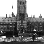 Photo showing several of the banners representing different Québec and francophone women's groups in front of the Parliament Building in Ottawa. They were part of the Banner Project which asked groups across Canada to produce a protest banner that would become part of a huge banner in Ottawa. The goal was to show the strength and solidarity of women during the Third Commonwealth meeting of Ministers Responsible for Women’s Affairs in October 1990.