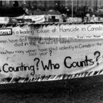 This banner was part of the Banner Project and focuses on the extent of wife assault and homicide in Canada. The Banner Project asked women's groups across Canada to produce a protest banner that would become part of a huge banner in Ottawa. The goal was to show the strength and solidarity of women during the Third Commonwealth meeting of Ministers Responsible for Women’s Affairs in October 1990.