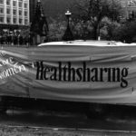 Healthsharing's banner calls for free accessible healthcare for all women. It is one section of a huge banner made up of individual protest messages created by women's groups across Canada. The goal was to show the strength and solidarity of women during the Third Commonwealth meeting of Ministers Responsible for Women’s Affairs in October 1990.