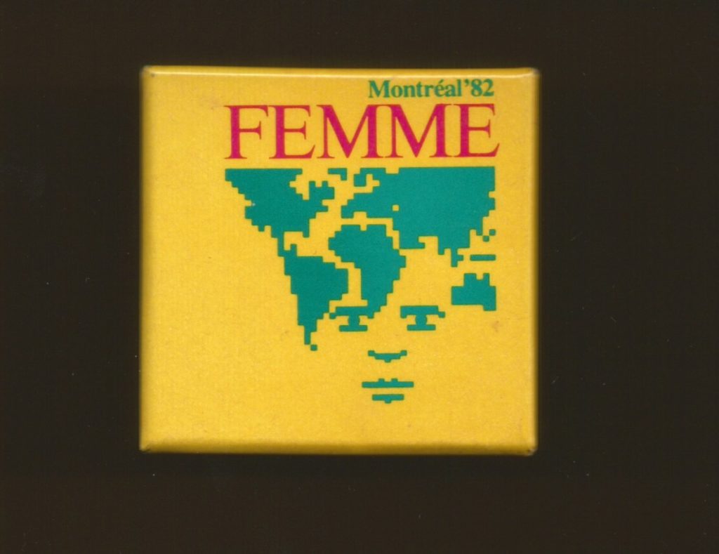 A 1982 button from Montreal with an image showing a woman's face embedded in a map of the world.