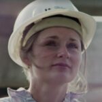 Film still from 'I want to be an Engineer' of a woman wearing a white hard hat.