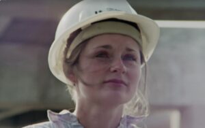 Film still from 'I want to be an Engineer' of a woman wearing a white hard hat.