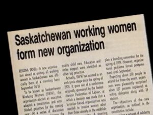 Film Still from 'It’s Not Over Yet – Saskatchewan Working Women" of a newspaper article titled "Saskatchewan Working Women form new organization".