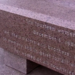 Still from the film "Marker of Change" depicting a stone slab with a description of the Montreal massacre etched into it.