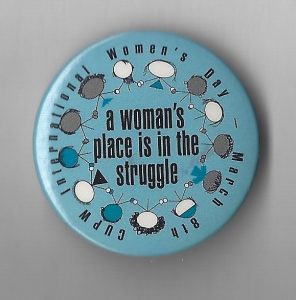 This is an undated button created by Canadian Union of Postal Workers in celebration of March 8th, International Women's Day.