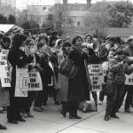 This is a photo of a rally at Toronto City Hall held by CUPE library workers who were on strike at the Metro Toronto Reference Library in 1984. Judy Darcy, head of the Strike Committee, is holding the megaphone.