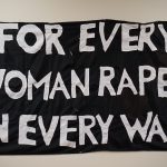 The banner For Every Woman Raped in Every War was produced by the Feminist Action Collective and used in an action with the poem of the same name on November 11, 1979, at the War Memorial on Wellington street, Ottawa. The banner was sewn at the Ottawa Women's Centre by a number of women who dropped in and picked up a threaded needle. - Wendy McPeake fonds 10-032, Canadian Women’s Archives, University of Ottawa Archives and Special Collections