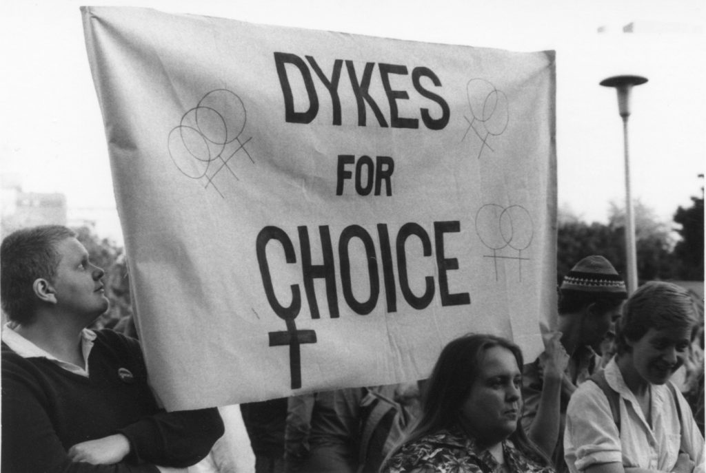 This photo of Dykes for Choice was taken at a rally in support of Dr, Morgentaler and the Toronto abortion clinic in 1983. From left to right: Christine Donald, Heather Ramsay, Gay Bell, and Virginia Adamson.