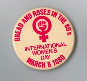 Button designed for the Toronto 1980 International Women's Day March organized around the theme "Bread and Roses for the 80s"