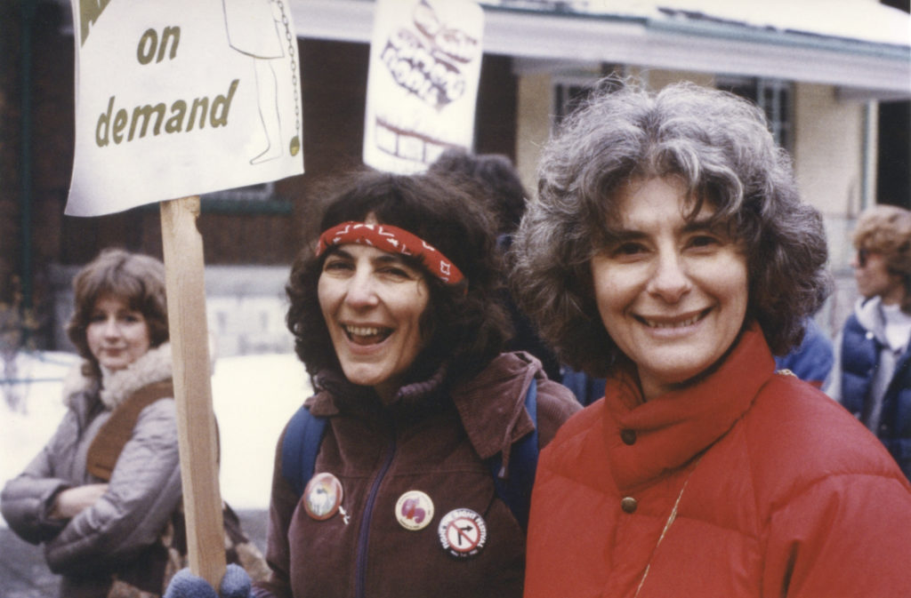 Shelley Glazer and Sheila Miller walk with Free Abortion on Demand placard at 1982 International Women's Day March in Toronto.