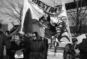 The photo taken at the 1990 International Women's Day March in Toronto shows the banner of Voice for Guatemalan Women.