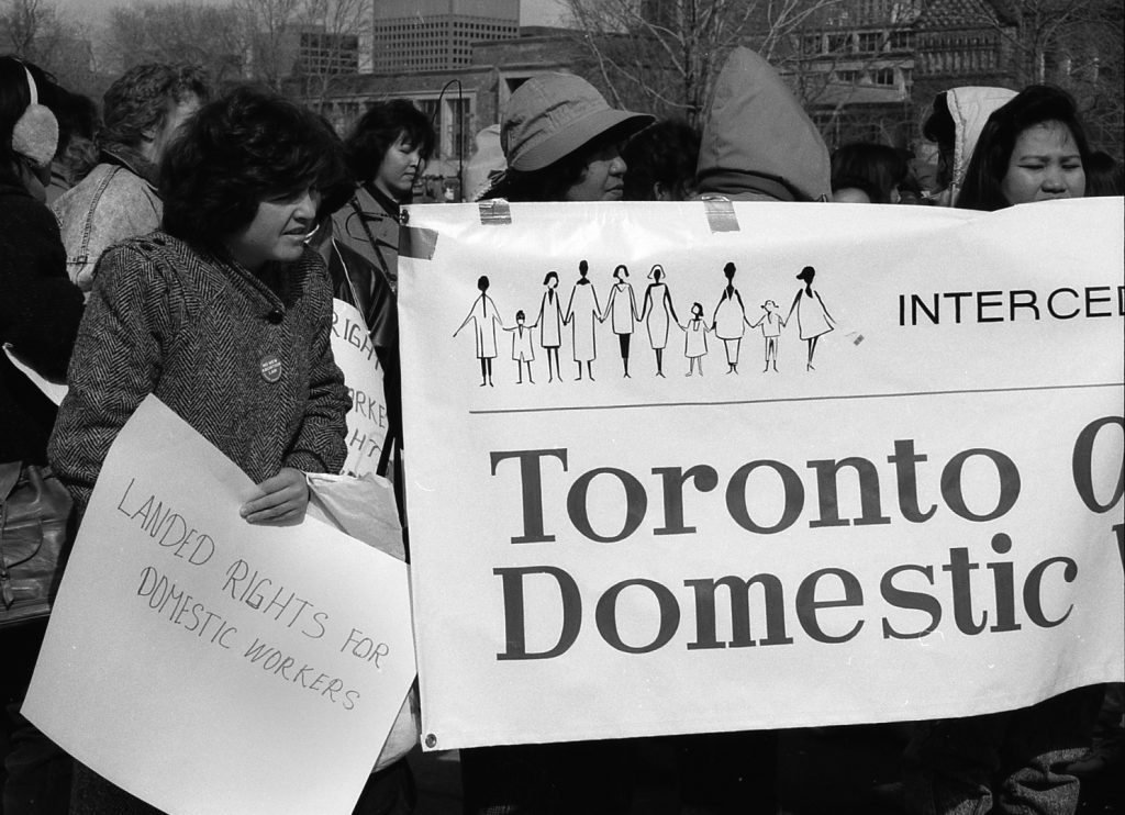 A photo of the INTERCEDE contingent and banner at 1990 International Women's Day March in Toronto.