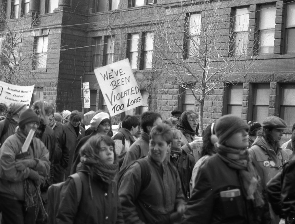 Placards at the 1990 International Women's Day March in Toronto focus on ending violence against women and children. Photograph by Amy Gottlieb.