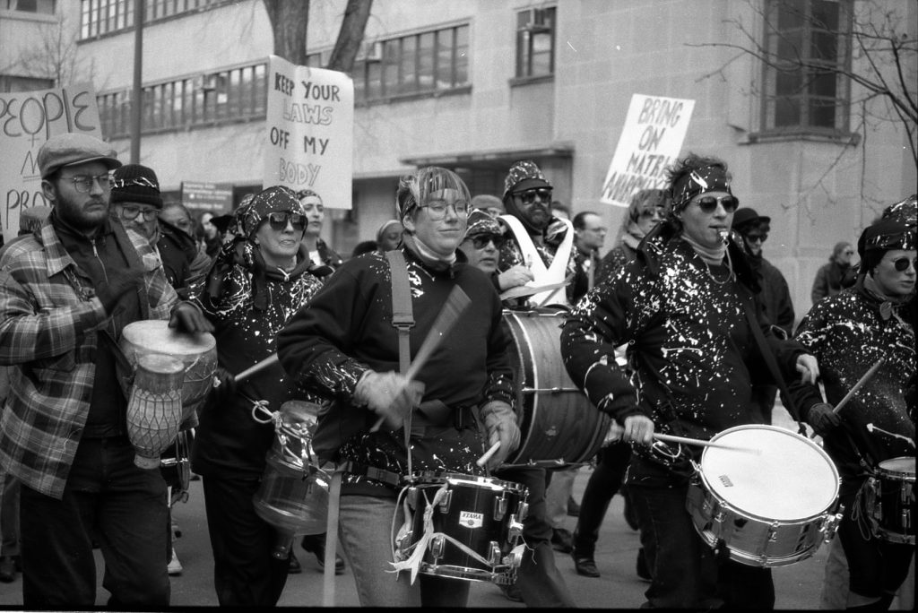 The Shadowland "Shitheads" drummers join the March 1990 celebration of the International Women's Day in Toronto. Vanessa Alexander and Joanna Kidd are in the front row, with Leida Englar behind. Photograph by Amy Gottlieb.