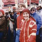 This is an undated photo of union women at the Toronto International Women's Day March. Placards feature OPSEU and the Canadian Labour Congress calls for an End to Sexual Harassment and Equal Pay.