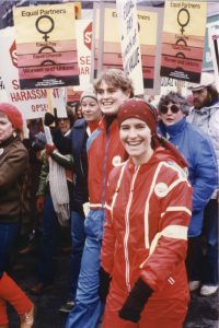 This is an undated photo of union women at the Toronto International Women's Day March. Placards feature OPSEU and the Canadian Labour Congress calls for an End to Sexual Harassment and Equal Pay.