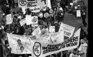 Banners for the Federation of Women Teachers' Association of Ontario and the Congress of Canadian Women are seen contingents at the 1983 International Women's Day March in Toronto.