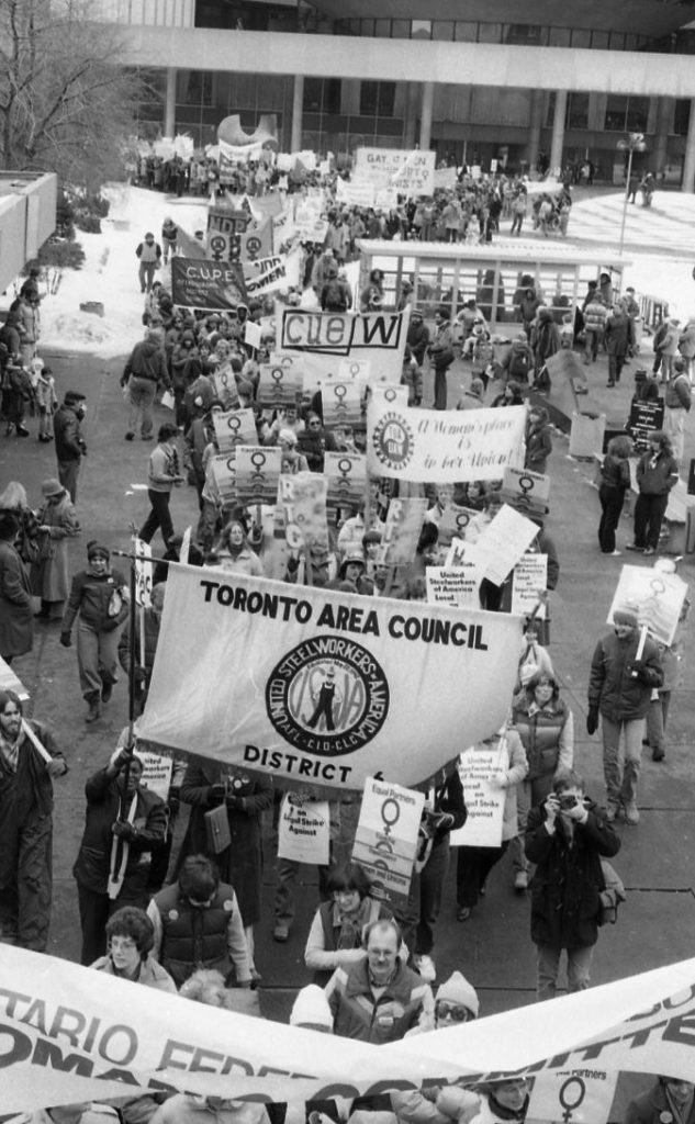 United Steelworkers Toronto Area Council march at the International Women's Day 1983 March in Toronto. Banners of other unions can also be seen in the background.