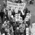 Action Daycare and other childcare activists join the 1983 International Women's Day March in Toronto. Signs call for universal quality daycare and paid maternity leave.